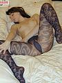 Teen with firm ass poses in snake pattern stockings